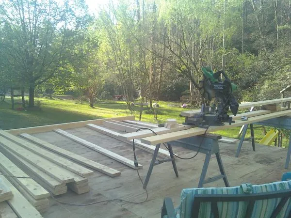 Miter saw and framing lumber on a deck under construction in Morrow